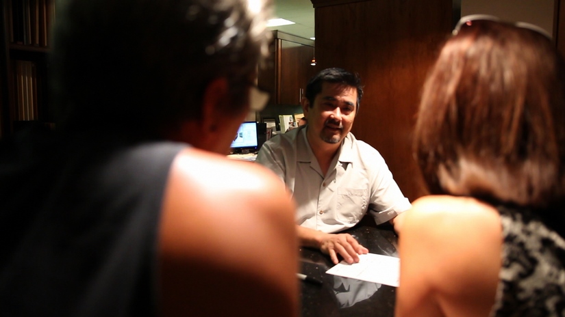 Randall Omoto, Sales Manager at Homeowners Design Center, consults with a couple about their kitchen remodel