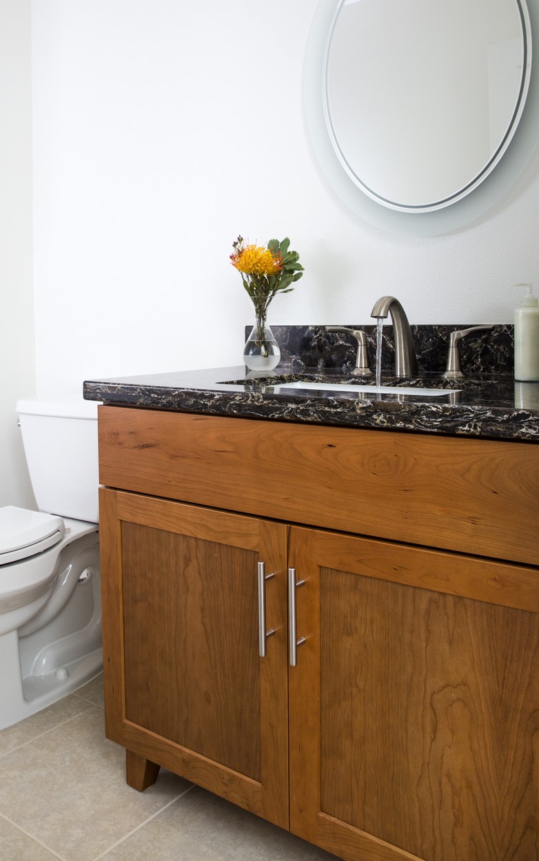 For the sink in the gazebo powder room, Homeowners Design Center created a furniture piece by removing the toe kick space and adding feet.