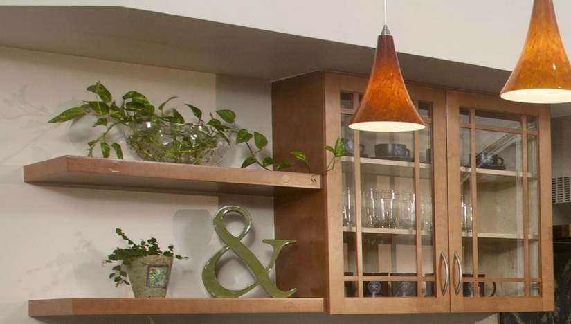 Cabinets by Kitchen Craft fitted with floating shelves and glass doors helped to add openness to the kitchen.