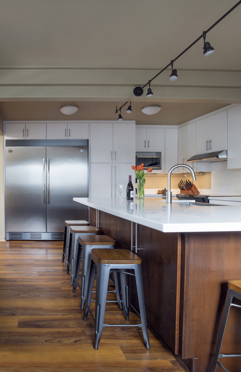U-shaped kitchen transformed into an L-shape for easier flow.
