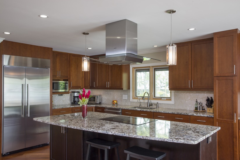 New kitchen island with a unique and functional shape being the focal point of the enlarged kitchen.