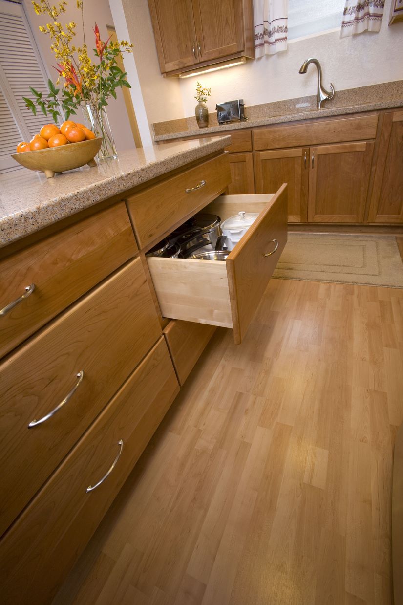 A peg board system is used for the deep drawers to create even more space in the expansive kitchen design.