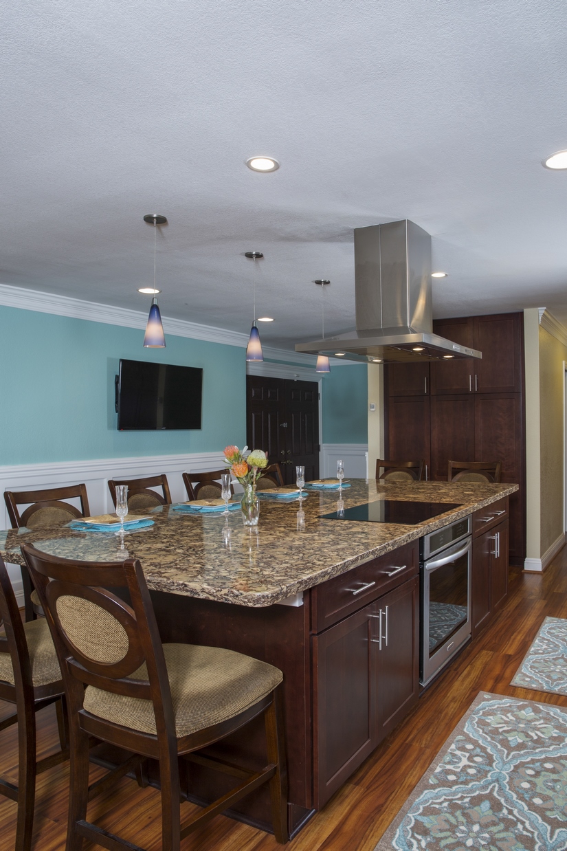 The large island became the focal point of the space; able to comfortably seat eight with the stovetop at the center.