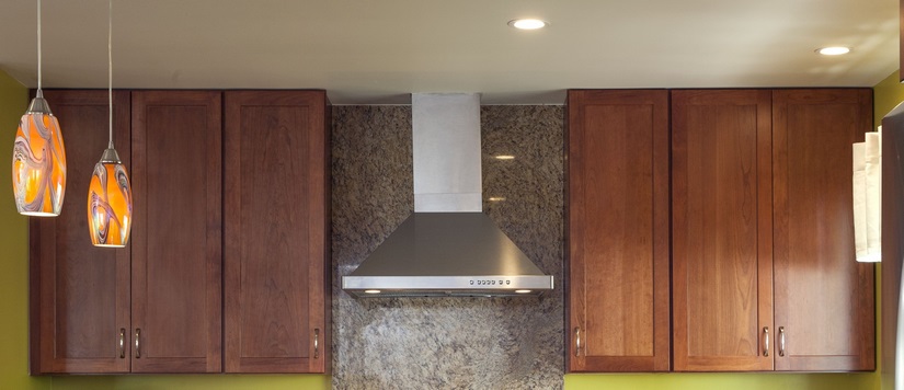 Cherry wood cabinets stained in briarwood infused the kitchen with a warm and inviting look and complemented the vinyl flooring.